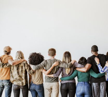 Rearview of diverse people hugging each other